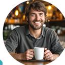 Esteve Whitmyer, parent of a college student, smiling with a coffee mug